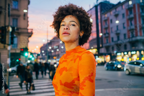 Portrait carefree young black woman outdoor posing outdoors city night cool confident attitude