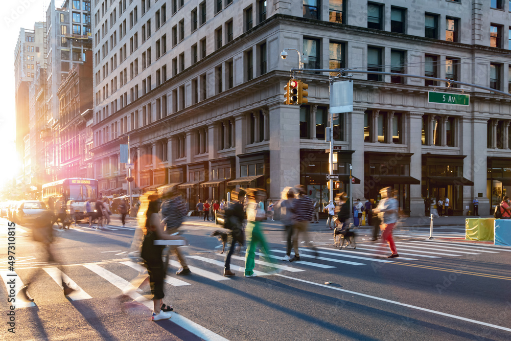 Colorful crowds of people walking through the busy intersection on 23rd Street and 5th Avenue in New York City
