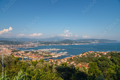 Sunny panoramic view of the city and the bay, port for ships from the distance. Tourism and transport. Rest and travel. Summe day. © Sergey