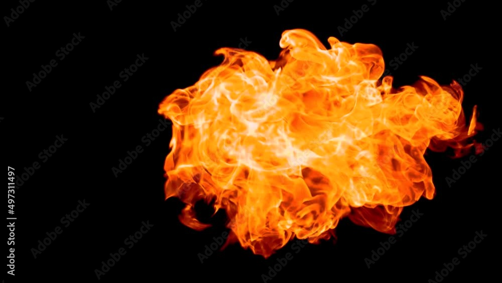 Flashes of flame rise from an upward corner of the frame. Flame isolated on black background. Flashes of flame rise from an upward corner of the frame. Flame isolated on black background.