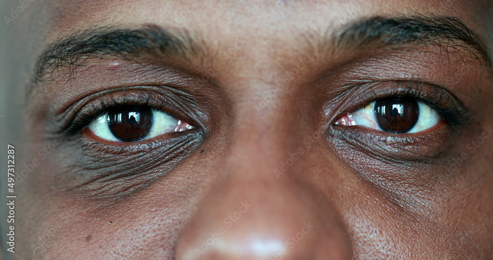 African man meditating close-up eyes African man meditating close-up eyes