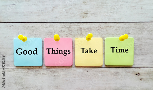 Obraz na płótnie Good things take time slogan written on sticky notes on wooden background