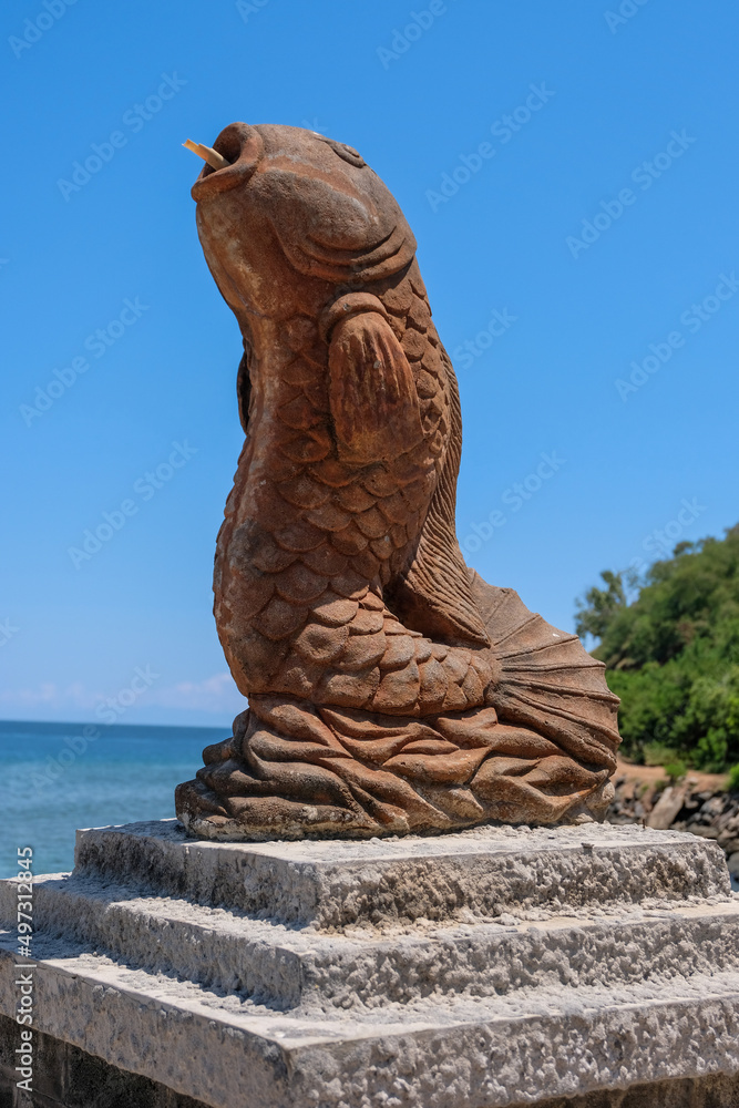 A tropical fish sculpture statue of a large tropical fish at the entrance to popular Cristo Rei beach in Dili, Timor Leste A tropical fish sculpture statue of a large tropical fish at the entrance to popular Cristo Rei beach in Dili, Timor Leste