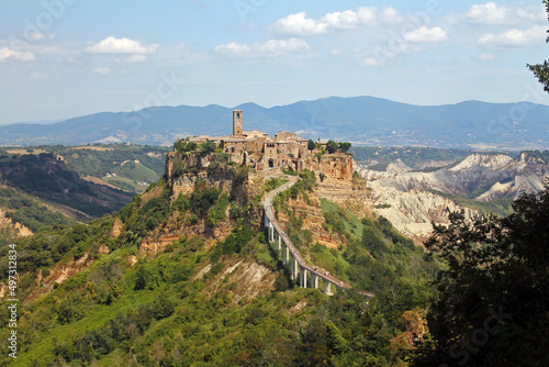 The historical civita village of Bagnoregio standing on a cliff with the long pedestrian bridge