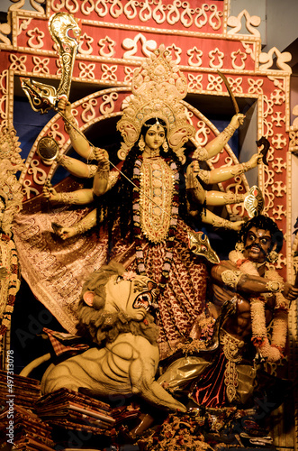 Fotografie Mother Goddess devi with bow and arrows, conch shell, sword, shield and lion in durga puja or durga ashtami