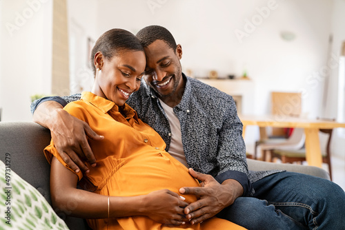 Photography Black expectant parents sitting on sofa dreaming about their baby