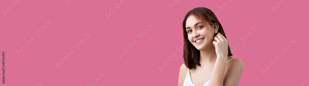 Beautiful smiling woman with clean skin, natural make-up and white teeth on a Pacific Pink background Beautiful smiling woman with clean skin, natural make-up and white teeth on a Pacific Pink background