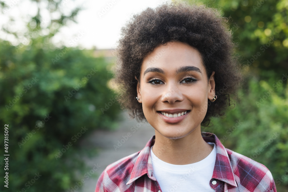 portrait of curly african american farmer smiling at camera outdoors. portrait of curly african american farmer smiling at camera outdoors.