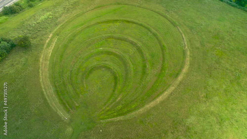 Aerial backward tilt up reveal over Theydon Bois Earthwork sculpture, Epping in UK Aerial backward tilt up reveal over Theydon Bois Earthwork sculpture, Epping in UK