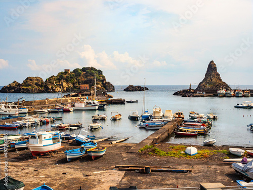 the blue sea of Acitrezza, in Sicilia near Catania, Italy, and its faraglioni