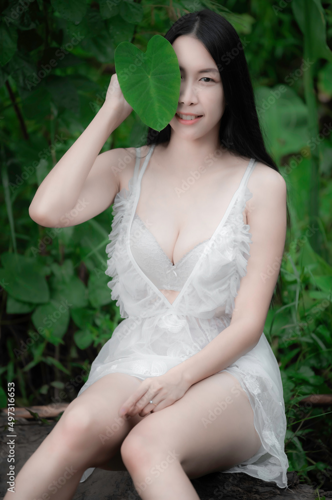 Portrait of sexy asian woman at the waterfall,Feeling fresh at the river,Thai female relax at country Portrait of sexy asian woman at the waterfall,Feeling fresh at the river,Thai female relax at country