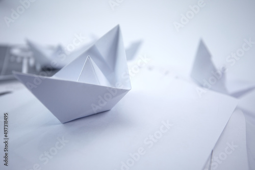 business concept- paper boats on the paper