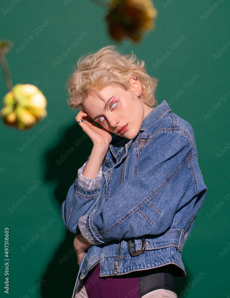 young fashion beauty girl on a green background in a jeans jacket young fashion beauty girl on a green background in a jeans jacket