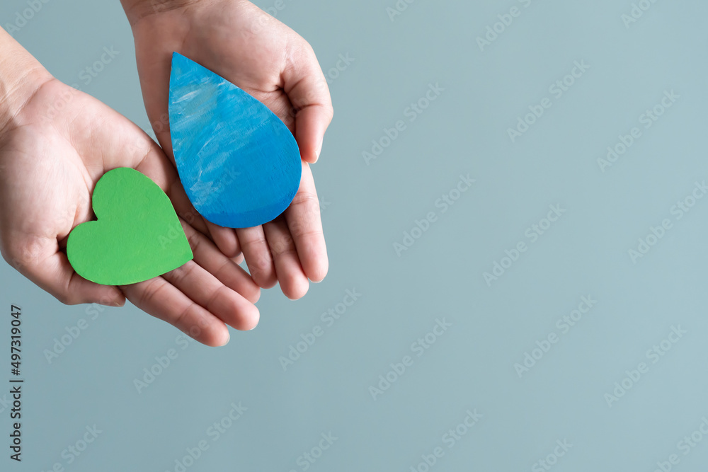 Hands holding green heart and water drop concept of save water save the world. Hands holding green heart and water drop concept of save water save the world.