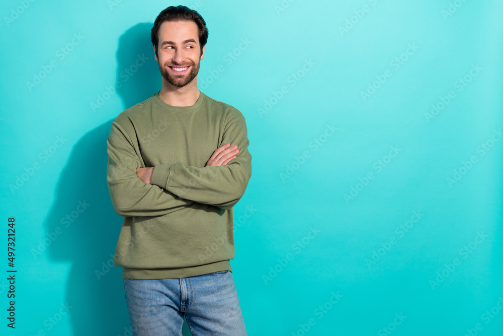 Photo of cool brunet young guy crossed palms look promo wear green sweatshirt isolated on teal color background Photo of cool brunet young guy crossed palms look promo wear green sweatshirt isolated on teal color background