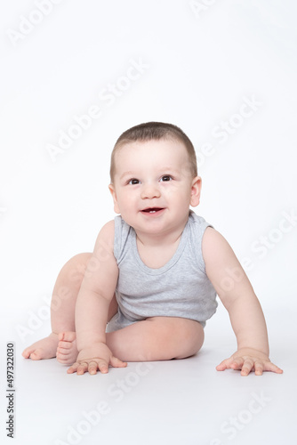 cute baby boy sit or crowl , closeup portrait of adorable child isolated on white background, sweet toddler healthy childhood, perfect caucasian infant, lovely kid, innocence concept