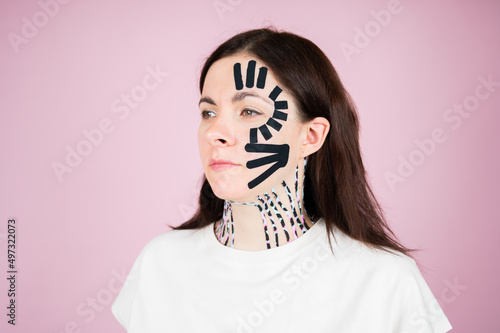 Young woman with kinesiology facelift tapes. Lifting skin concept. Anti-age face care concept