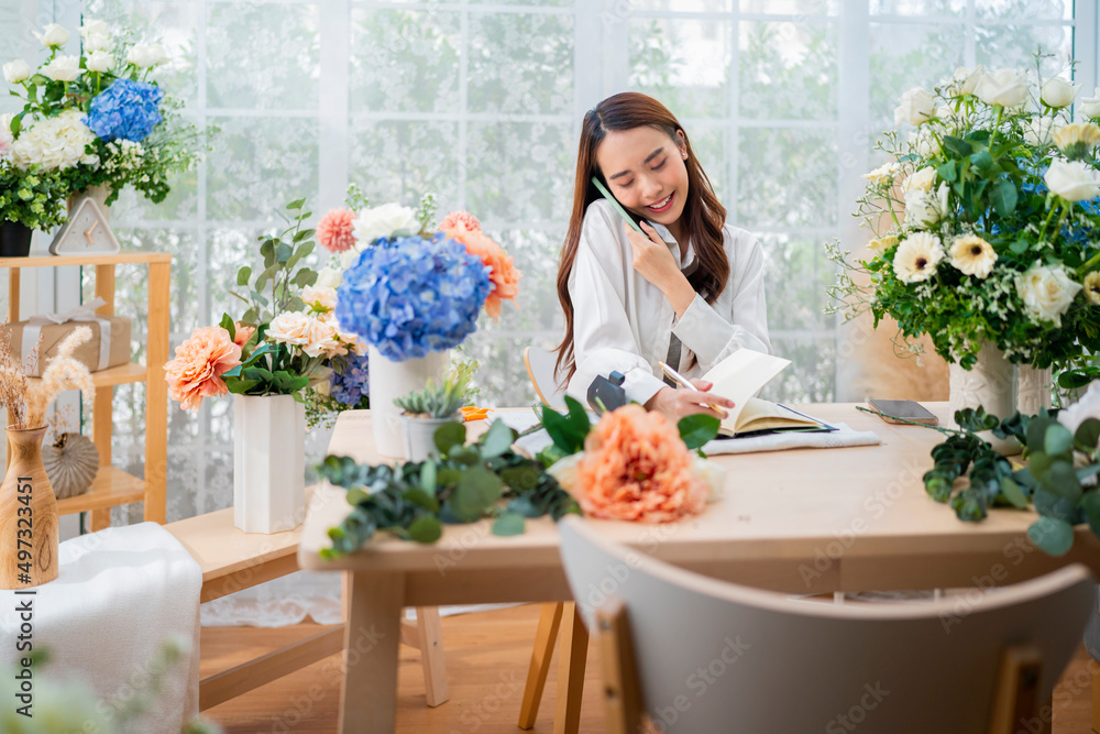 taking order florist working from home,young asian florist making list from client order to arrange flower bouqet vase delivery, Flower design store. happiness smiling young lady making flower vase taking order florist working from home,young asian florist making list from client order to arrange flower bouqet vase delivery, Flower design store. happiness smiling young lady making flower vase
