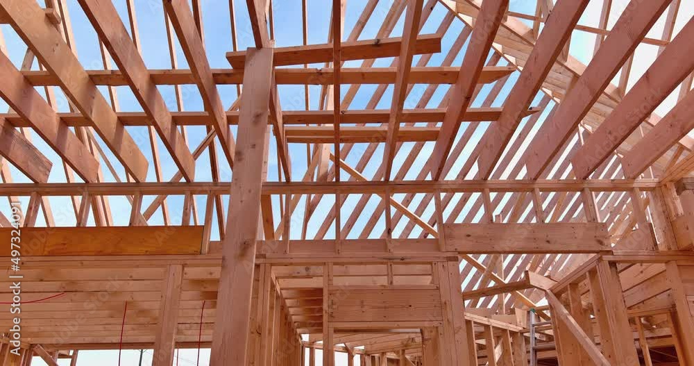 Roof trusses covered with condominium construction installation of wooden beams frame framework Roof trusses covered with condominium construction installation of wooden beams frame framework