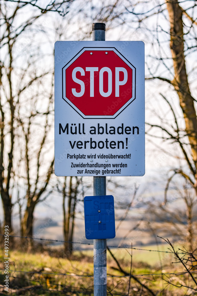 Foto de Stop sign dumping garbage prohibited in German language tries to prevent pollution do