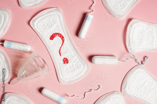 Close up pad, menstrual cup, tampon on a pink background. The view is flat. Concept of critical days, menstruation photo