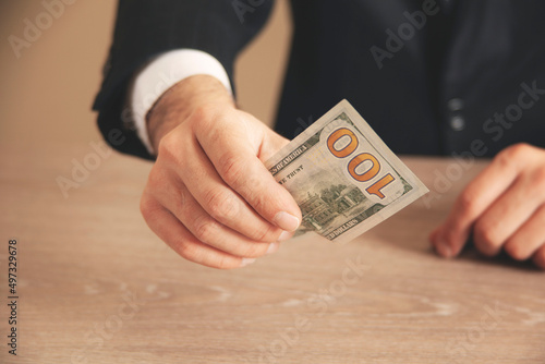 man hand holding money on dark background