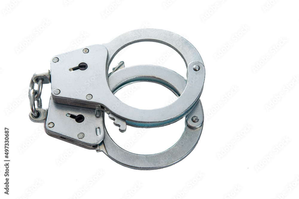 Obraz premium Metal handcuffs on a white isolated background, copy space