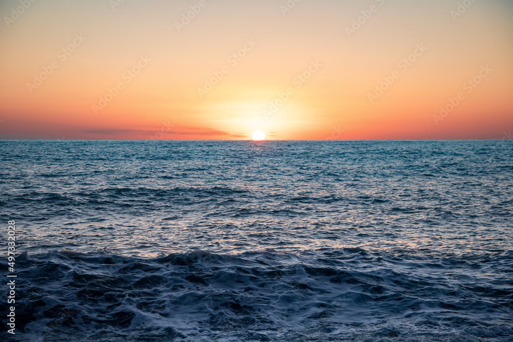 The sea wave. Sunset in the sea. The power of the elements. Landscape photography.