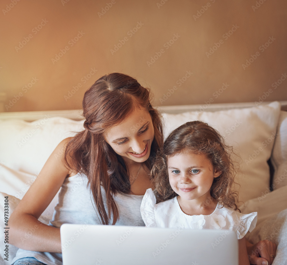 Which cartoon would you like to watch next. Shot of a mother and her little daughter using a laptop together at home. Which cartoon would you like to watch next. Shot of a mother and her little daughter using a laptop together at home.