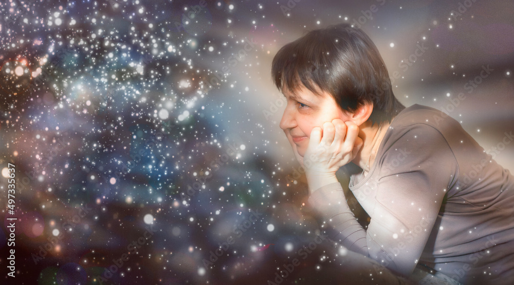 Woman looks at sparkles in anticipation of a miracle. Woman looks at sparkles in anticipation of a miracle.