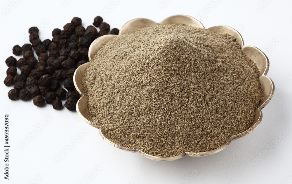 Indian spices Pepper Powder in brass bowl with pepper corn Indian spices Pepper Powder in brass bowl with pepper corn