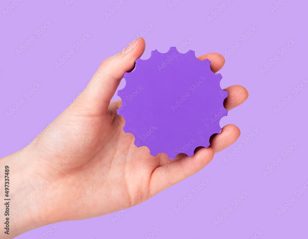 Settings concept. Woman hand holding gear on purple background. Applications technical parameters. High quality photo