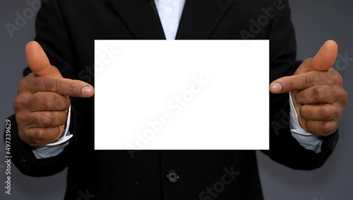 businessman with blank white card on grey background stock photo