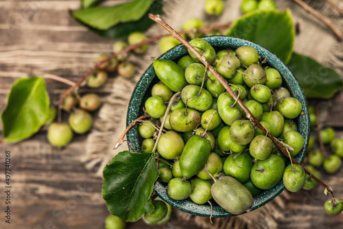 Harvest of ripe Actinidia arguta kiwi in a ceramic bowl