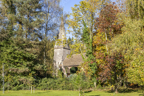 Autumn colours at the church of St John the Baptist in the Forest of Dean village of Huntley, Gloucestershire, England UK