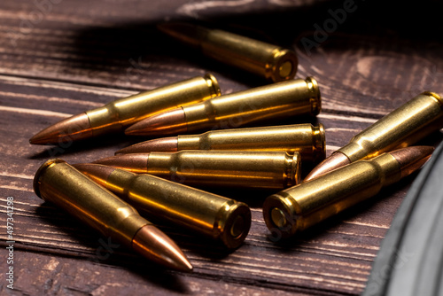 Bullets on wooden background. Cartridges 7.62 caliber for ak 47 closeup. Selective focus