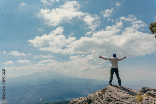 man standing on a mountain top