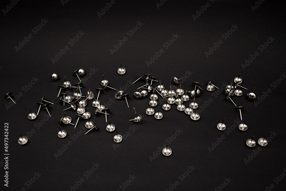 Metal push pins on background Metal push pins on background