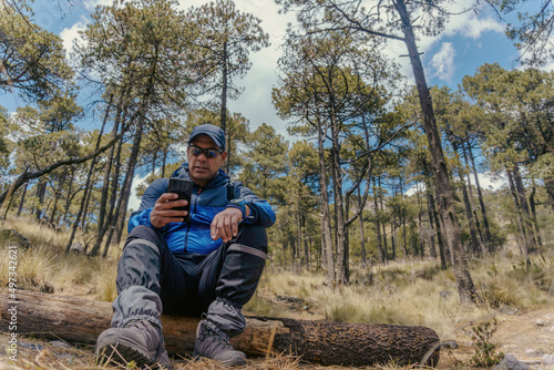 a man with phone in the forest