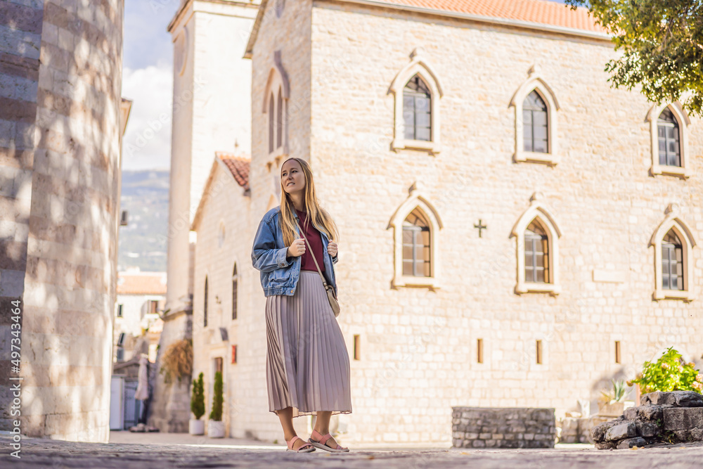 Young woman tourist in the old town of Budva. Travel to Montenegro concept