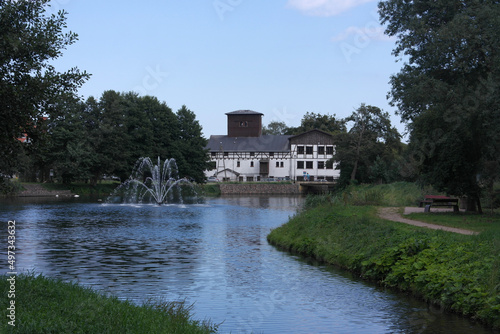 Green landscape, outdoors comfort place for rest: idyllic pond with fountain, coastal chill area zone, cozy house the old mill building . Baltic holidays inspiration, Gdansk, Poland. Oliwa, Stary Myn 