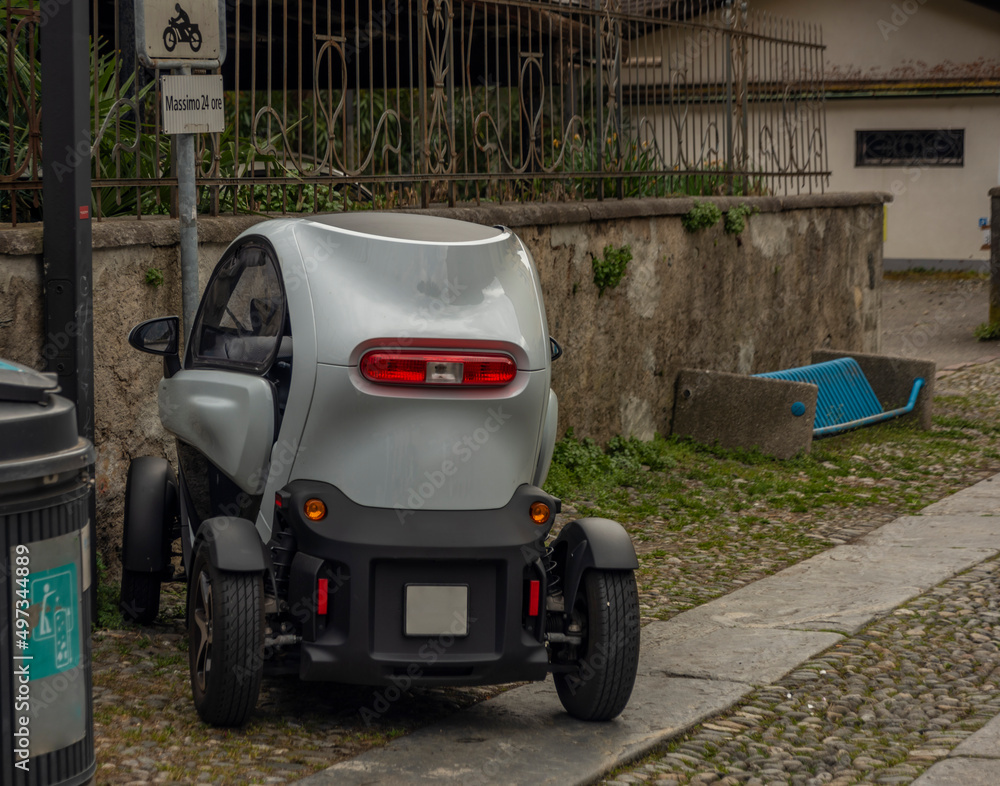 Small electric car in streets of Locarno town in spring day