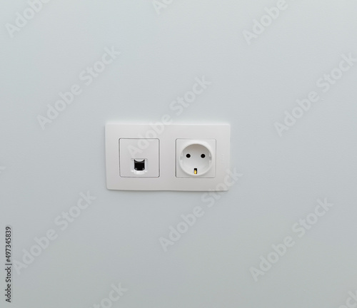 socket and connector for ftp cable in a plain wall. installed slots in the wall. concept of repair, electrical. white socket on a plain light wall