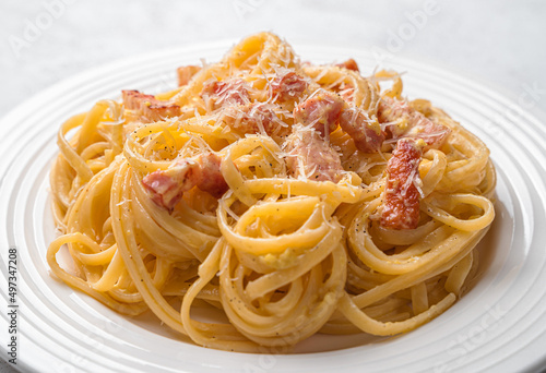 Traditional Italian pasta carbonara with bacon, egg, parmesan, cream and black pepper.