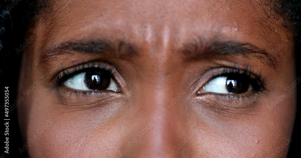 Fototapeta premium Upset African young woman macro close-up eyes, expressive angry black girl in discussion argument