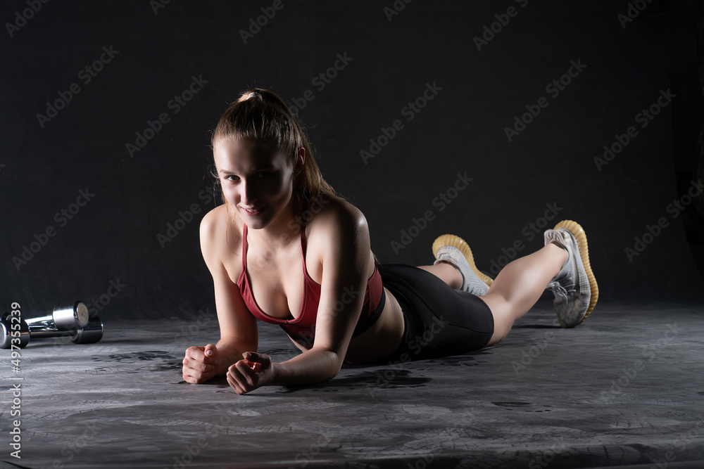 Obraz premium Dumbbells the a stands in plank with girl the on floor push-ups looks like a kira knightley girl fitness workout, for gym fit from woman for training athlete, strength sexy. Slim care weight