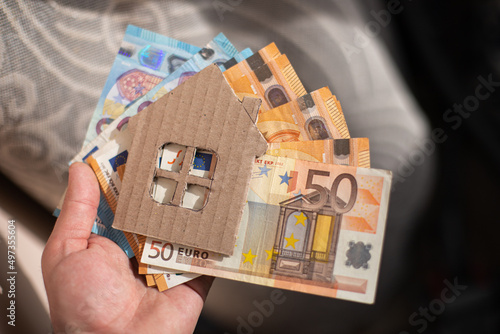 paper house on a background of euro money