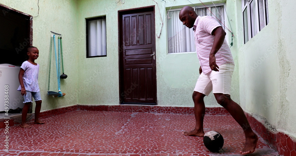 Parent and child bonding. father and son playing with ball together Parent and child bonding. father and son playing with ball together