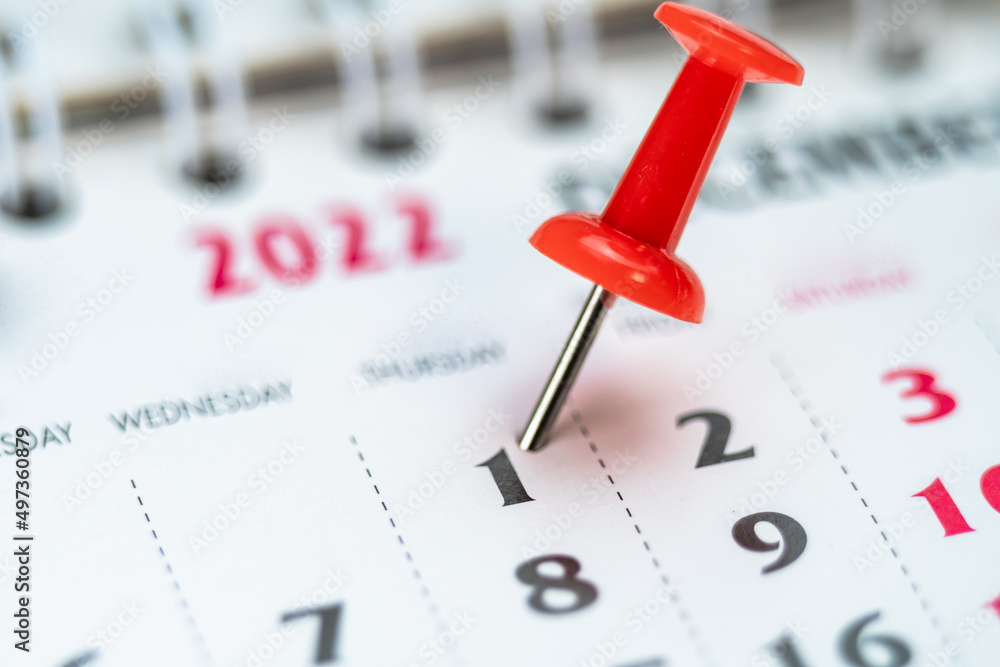 Red push pin on calendar 1th day of the month, mark the Event day with a Pin. Pin on calendar day one, date number 1. First day of the month is marked with a red thumbtack Red push pin on calendar 1th day of the month, mark the Event day with a Pin. Pin on calendar day one, date number 1. First day of the month is marked with a red thumbtack