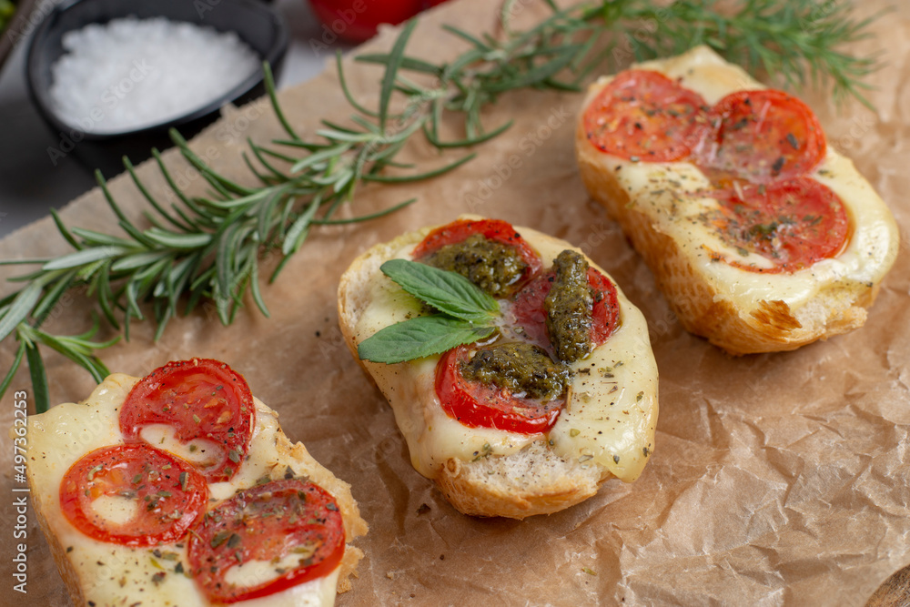 Bruschetta with tomatoes, mozzarella cheese and basil on a cutting board. Traditional italian appetizer or snack, antipasto